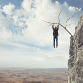 man-hanging-from-cliff-50%.png