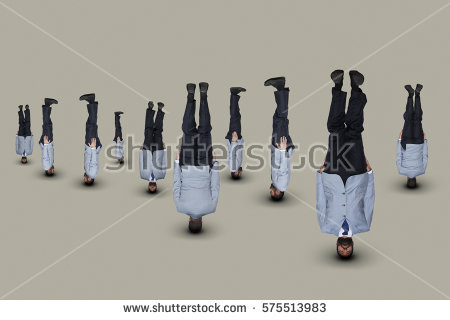 stock-photo-upside-down-businessmen-in-light-blue-suits-575513983.jpg