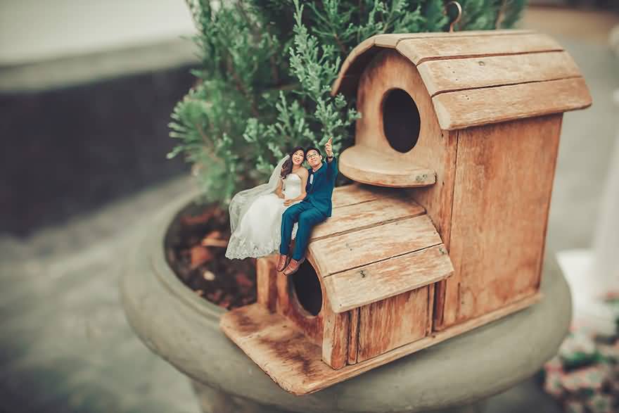 Miniature-Couple-Sitting-On-Toy-House-Marriage-Photography.jpg