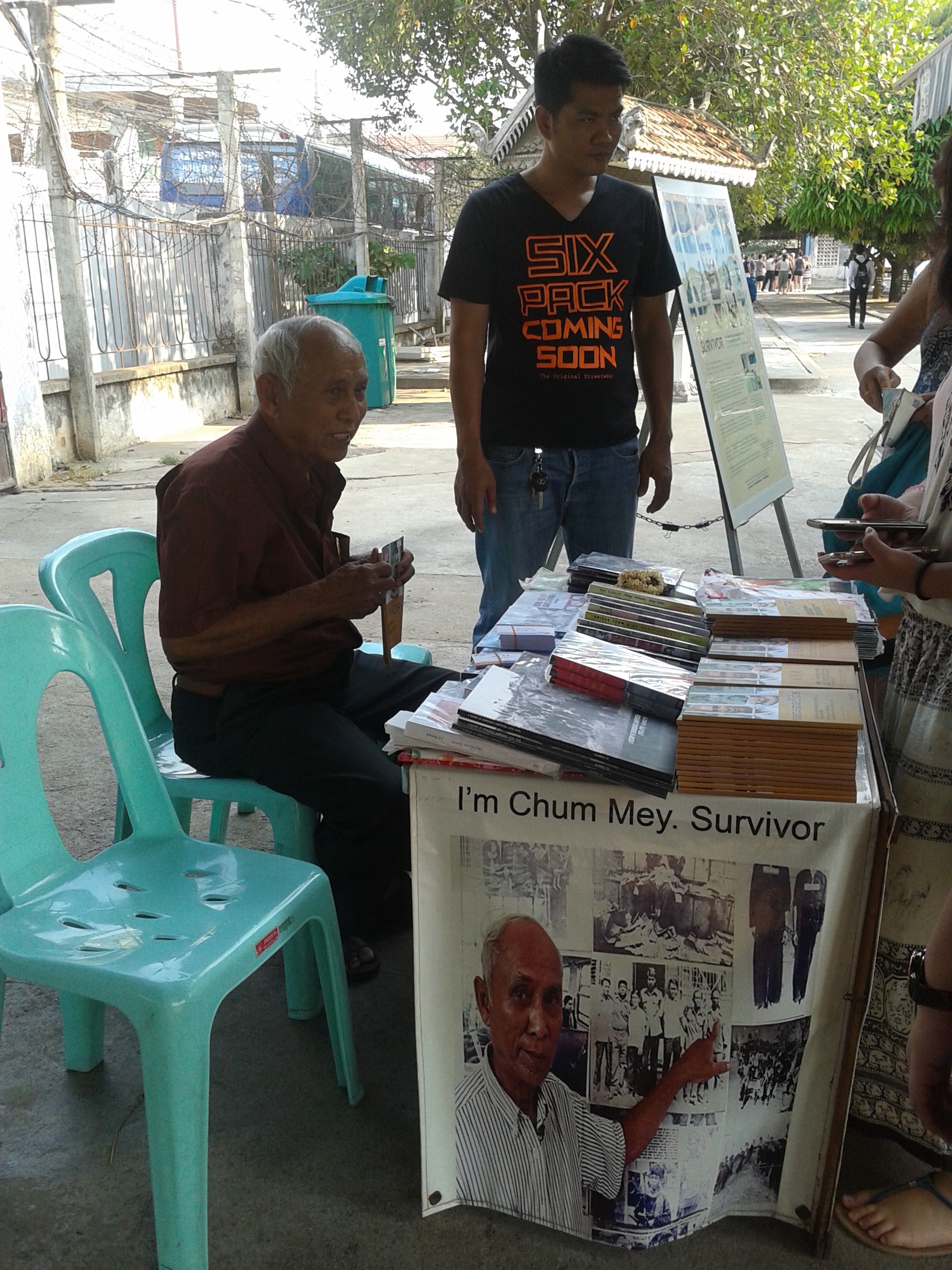 Chum May (seated) is one of the survivors and shared his part of the story into a book..jpg