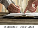 stock-photo-closeup-of-businessman-showing-his-new-business-partner-where-to-sign-an-agreement-or-contract-with-308142233.jpg