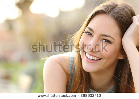 stock-photo-woman-smiling-with-perfect-smile-and-white-teeth-in-a-park-and-looking-at-camera-268932410.jpg