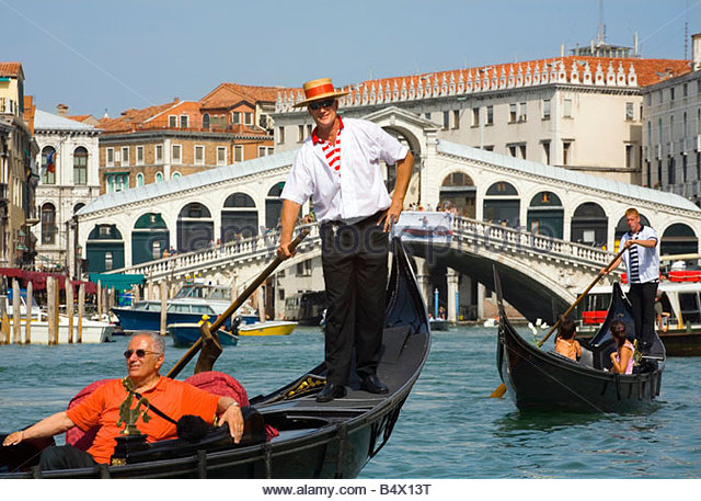 taking-a-gondola-ride-near-the-rialto-bridge-in-venice-italy-b4x13t.jpg