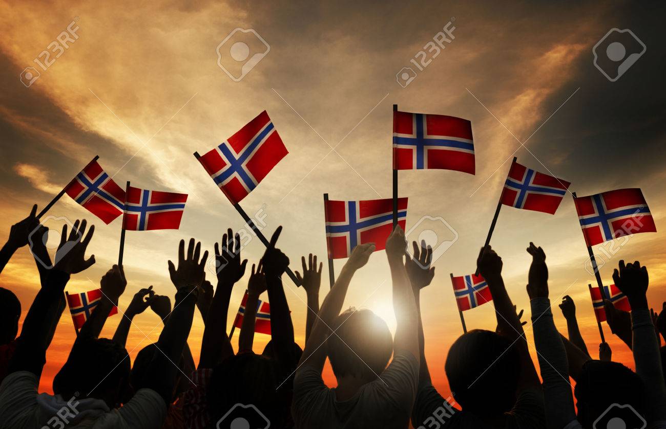31310464-group-of-people-waving-norwegian-flags-in-back-lit.jpg