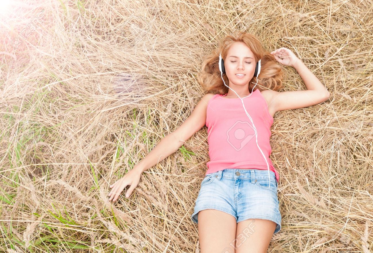 16249851-Beautiful-girl-relaxing-in-headphones-outdoors-Pretty-smiling-woman-with-closed-eyes-listening-to-mu-Stock-Photo.jpg
