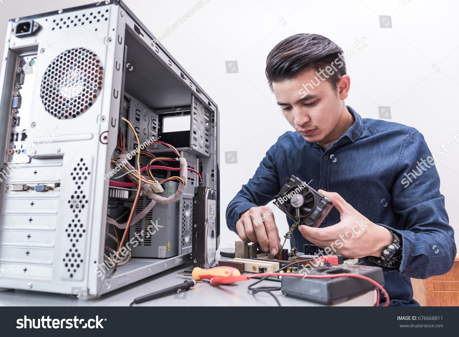 stock-photo-the-technician-put-the-cpu-cooling-fan-on-the-computer-mainboar.jpg