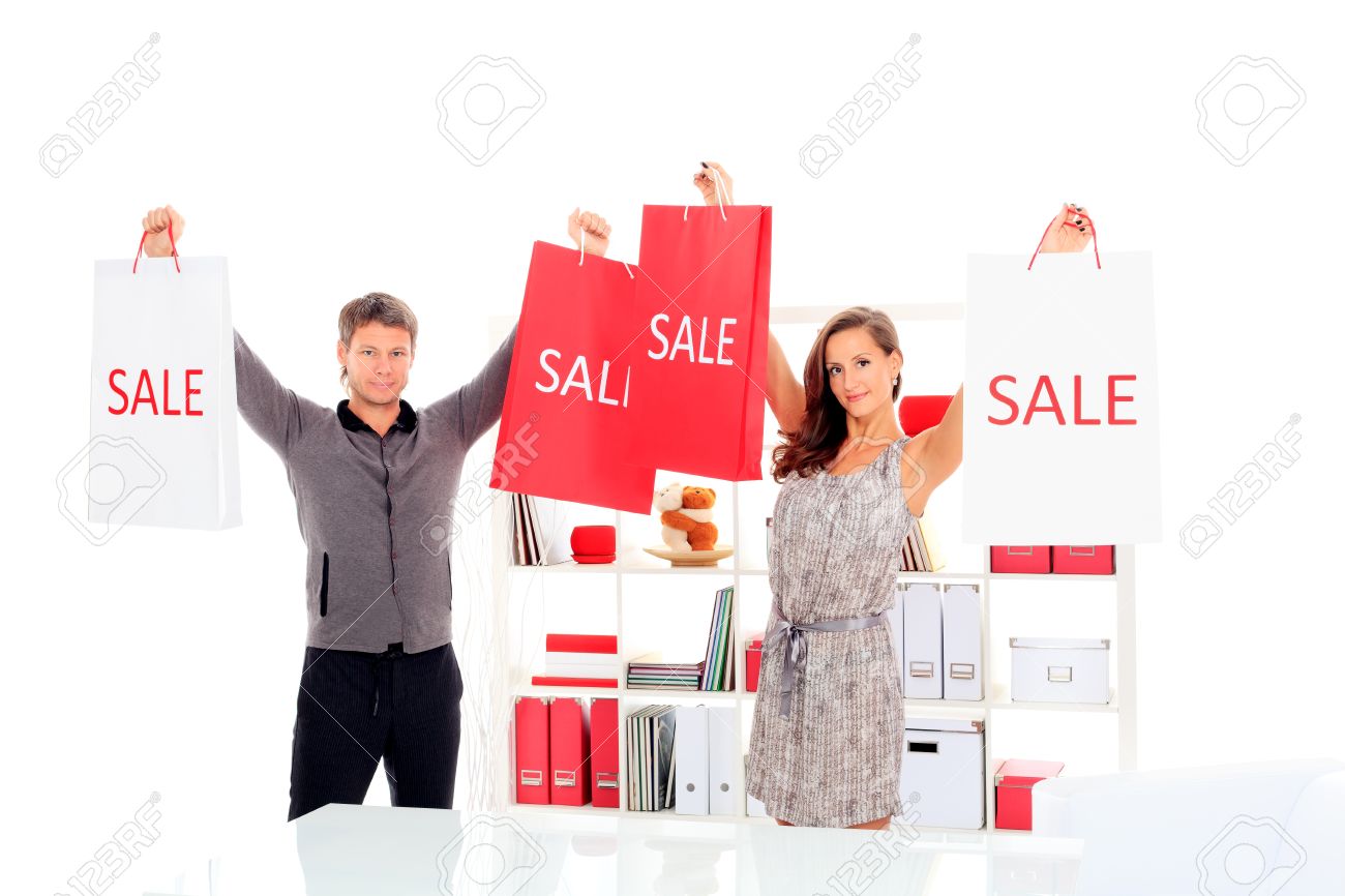 15116519-Seasonal-sale-happy-couple-holding-shopping-bags-inside-of-a-store--Stock-Photo.jpg