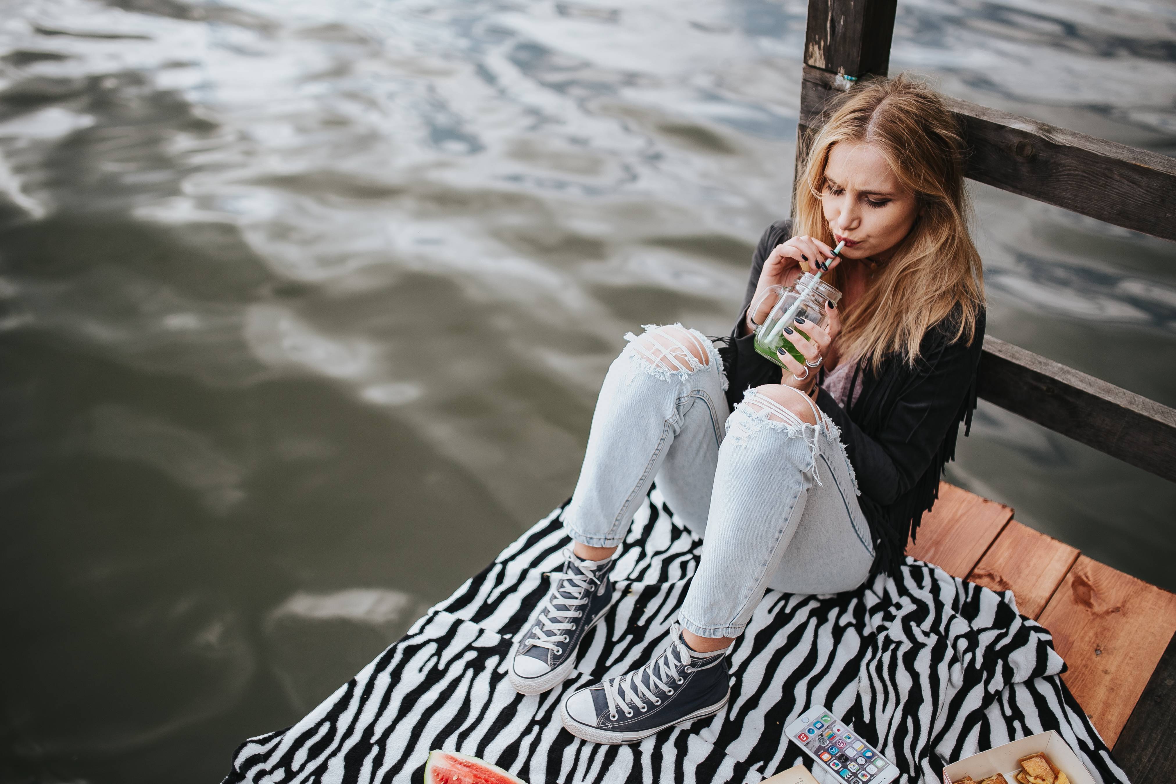 kaboompics_Blonde woman having a healthy snack at the wooden pier.jpg