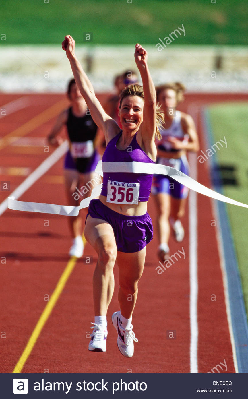 female-runner-victorious-at-the-finish-line-in-a-track-race-BNE9EC.jpg