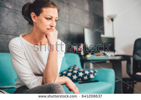 stock-photo-sad-woman-sitting-on-a-sofa-in-the-living-room-641208637.jpg