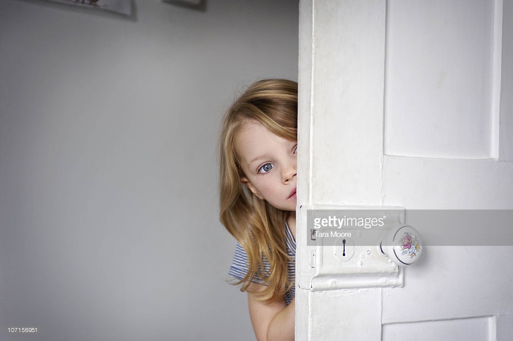 girl-peeking-head-around-door-picture-id107156951.jpeg