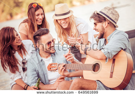 stock-photo-group-of-happy-young-people-having-a-picnic-on-the-beach-having-fun-together-649561699 (1).jpg