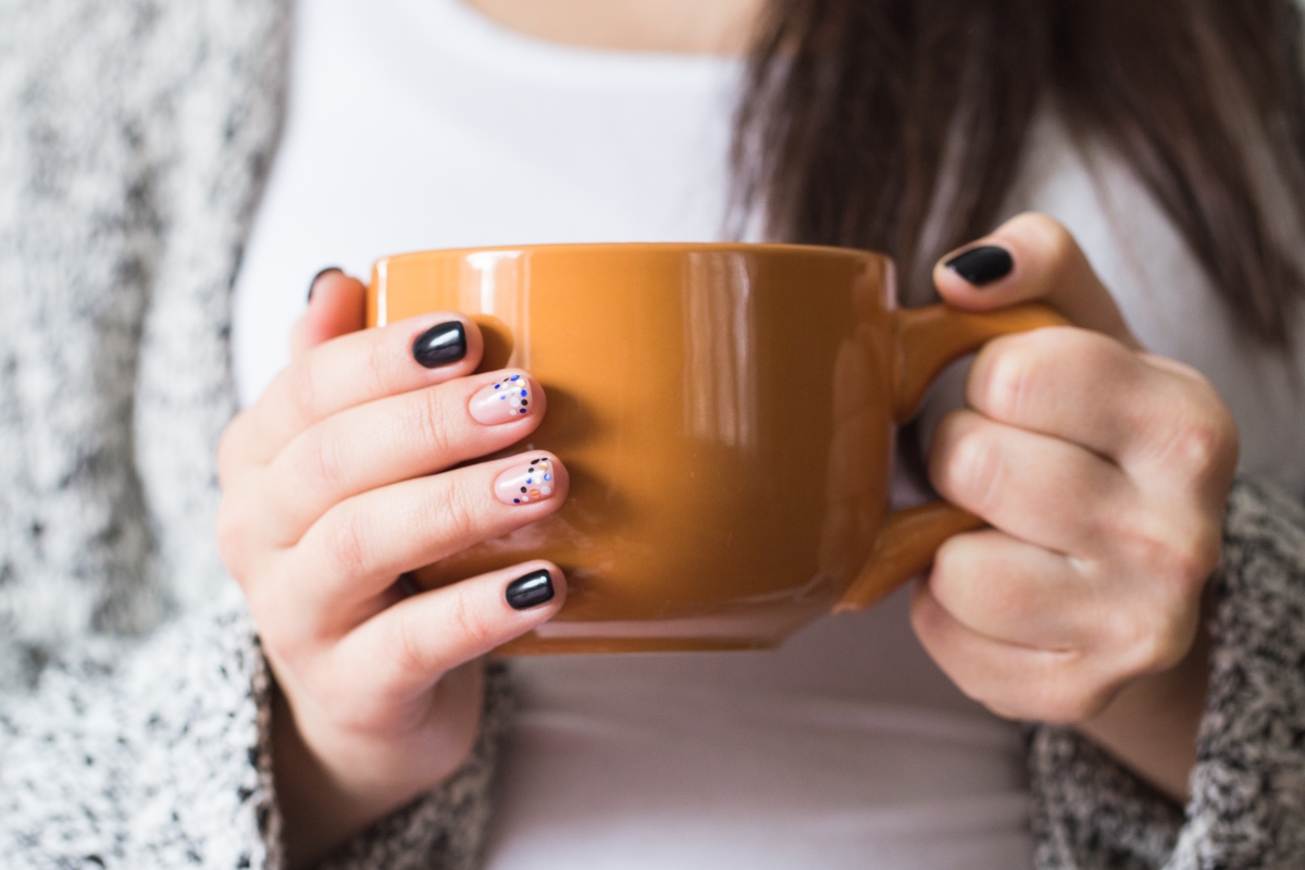 Optimized-a-young-pregnant-woman-holding-a-cup-close-up-PW54BHV.jpg