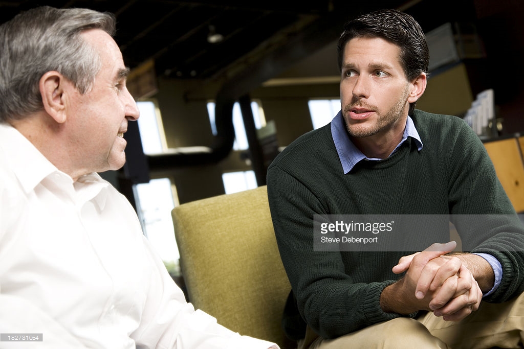 young-man-talking-and-praying-with-his-mentor-picture-id182731054.jpeg