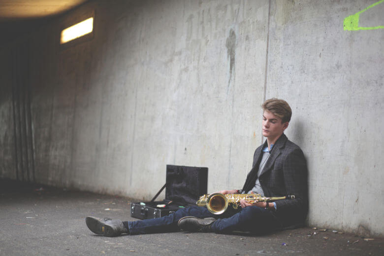 man-sitting-down-with-saxophone-780x520.jpg