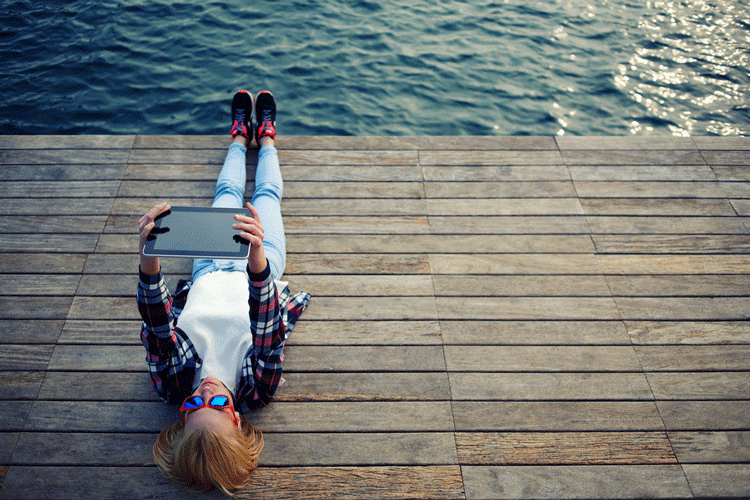 young-woman-laying-down-deck-oceanside-750x500.gif