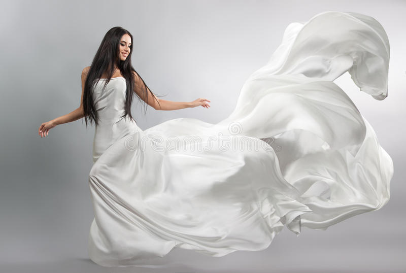 beautiful-young-girl-flying-white-dress-flowing-fabric-light-white-cloth-flying-wind-74827930.jpg