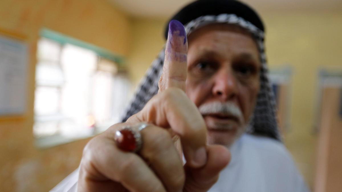 An-Iraqi-man-shows-his-ink-stained-finger-after-casting-his-vote-at-a-polling-station-during-the-parliamentary-election-in-the-Sadr-city-district-of-Baghdad.JPG