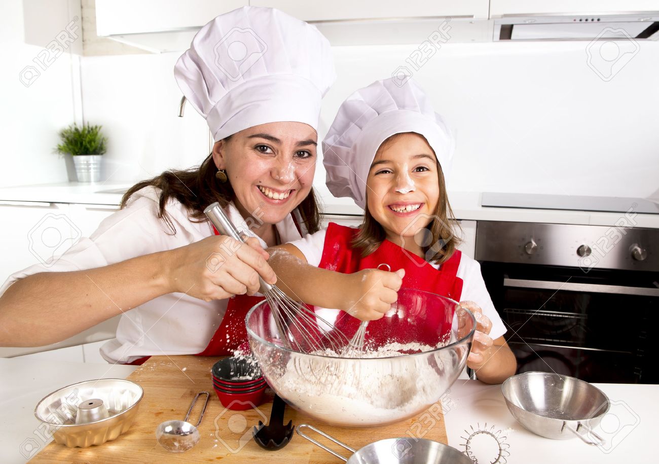 45948367-happy-mother-baking-with-little-daughter-in-apron-and-cook-hat-working-with-flour-bowl-and-spoon-pre-Stock-Photo.jpg