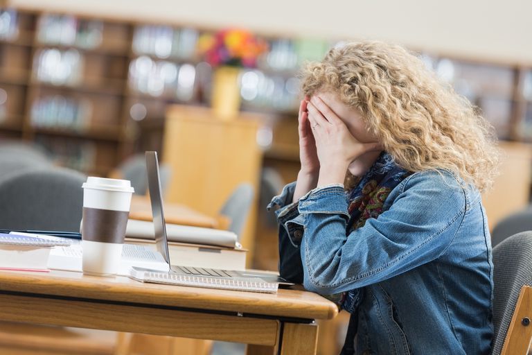 high-school-student-frustrated-while-studying-after-hours-in-library-469036472-589e16b65f9b58819ce0d75a.jpg