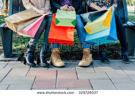 stock-photo-closeup-of-girls-with-colorful-shopping-bags-329726537.jpg