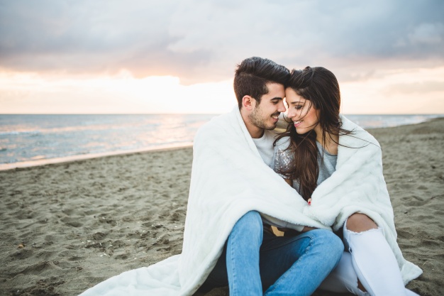 freepik loving-couple-sitting-on-a-beach.jpg