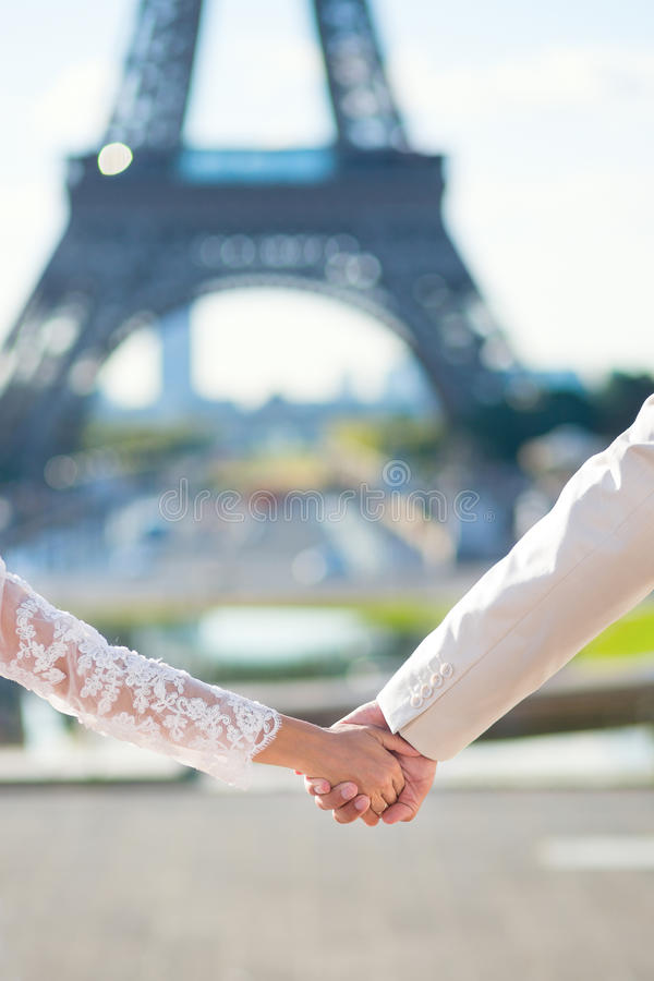 bride-groom-holding-hands-paris-their-wedding-day-45279295.jpg