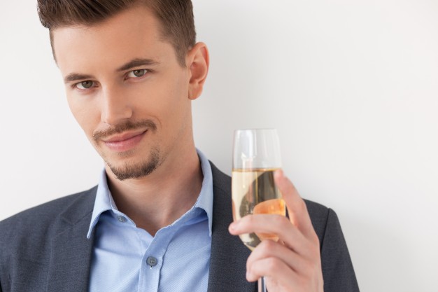 closeup-of-relaxed-young-man-holding-glass-of-wine_1262-2097.jpg