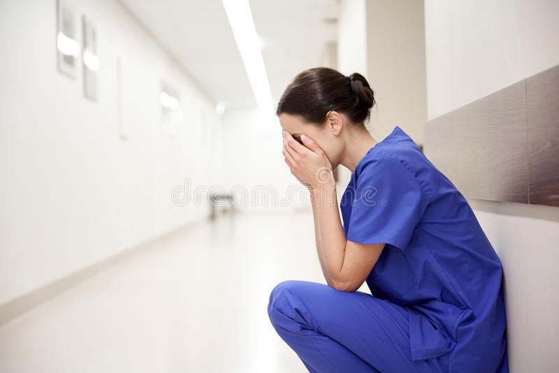 sad-crying-female-nurse-hospital-corridor-people-medicine-healthcare-sorrow-concept-78260472.jpg