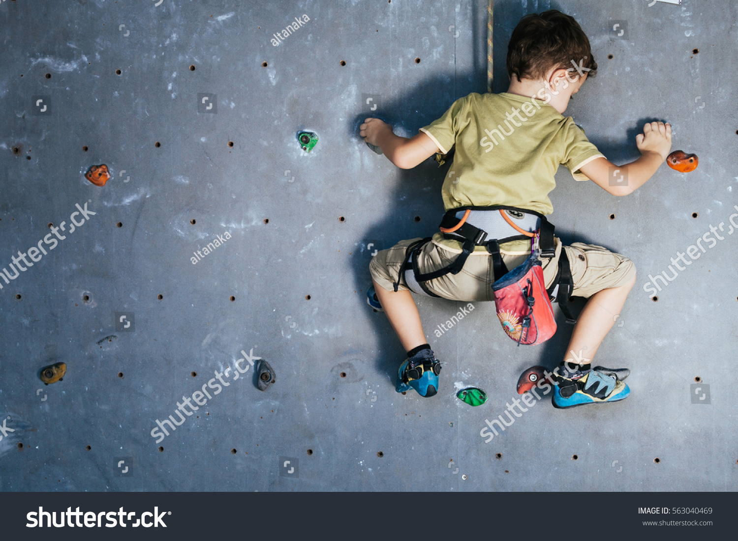 stock-photo-little-boy-climbing-a-rock-wall-indoor-concept-of-sport-life-563040469 (1).jpg