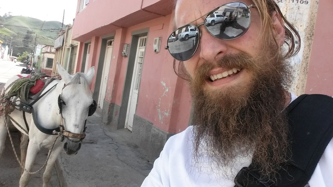 Alex taking selfie day two in the street with horses.jpg