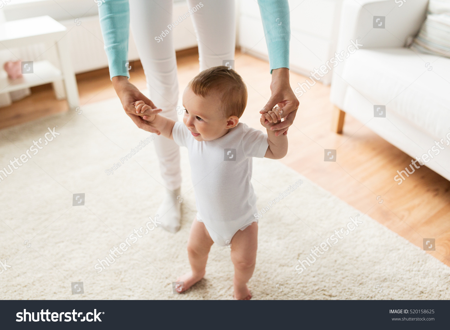 stock-photo-family-child-childhood-and-parenthood-concept-happy-little-baby-learning-to-walk-with-mother-520158625.jpg