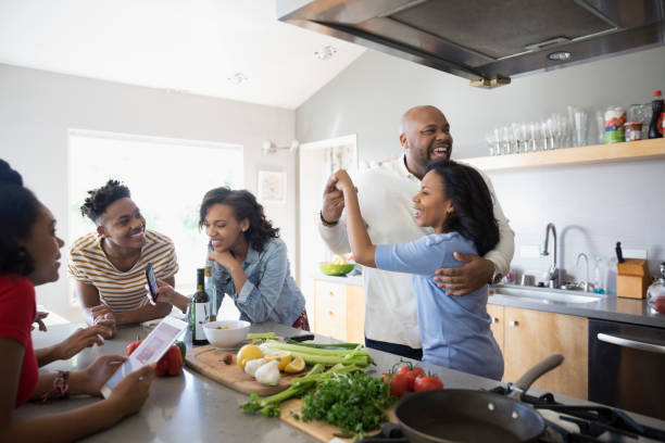 african-american-parents-dancing-and-cooking-with-children-in-kitchen-picture-id719874077.jpg