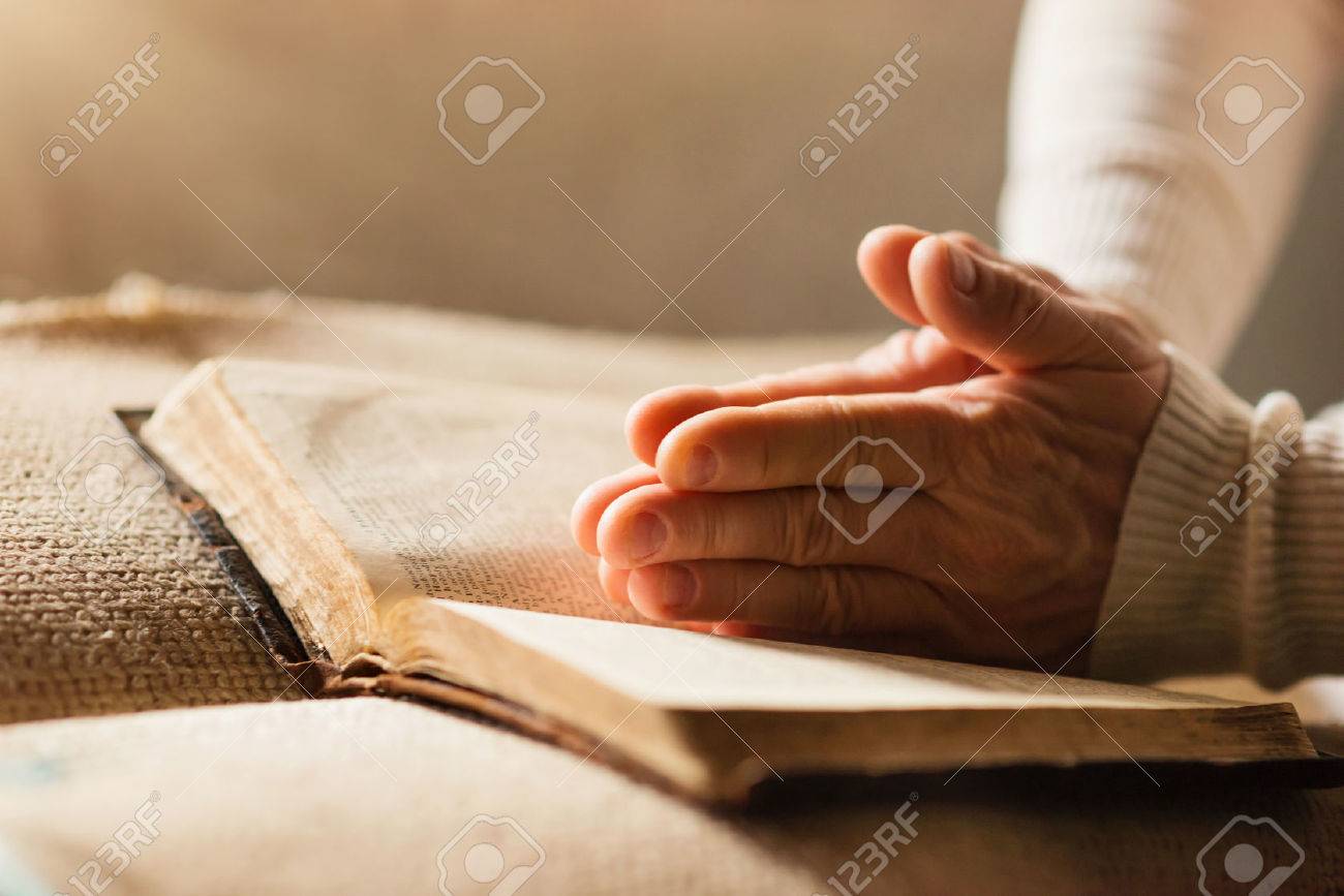 49172106-unrecognizable-woman-holding-a-bible-in-her-hands-and-praying.jpg