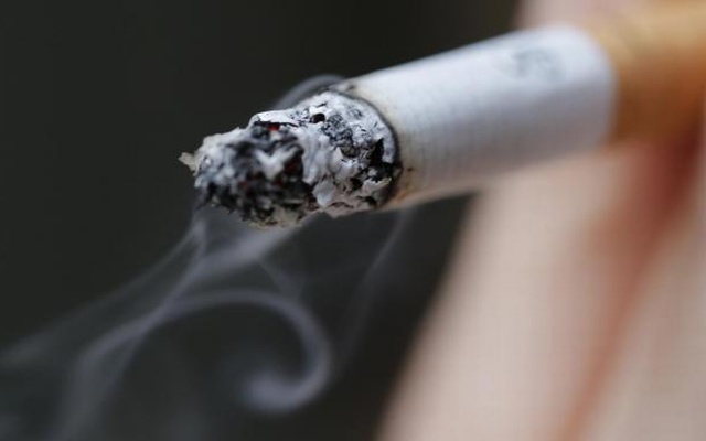 A woman smokes a cigarette in this illustration picture taken in Paris, Oct 8, 2014. Reuters.jpg