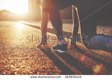 stock-photo-athlete-woman-in-running-start-pose-on-the-city-street-sport-tight-clothes-bright-sunset-blurry-593935445.jpg