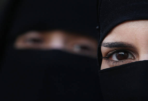 two-women-wearing-islamic-niqab-veils-stand-outside-the-french-a-picture-id111976662.jpeg