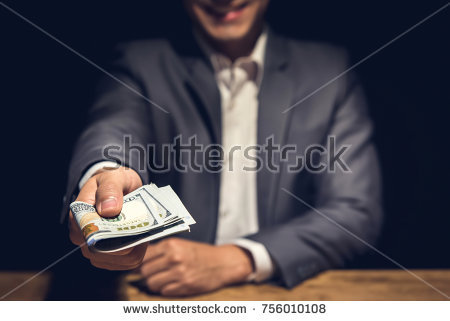 stock-photo-dishonest-corrupted-businessman-giving-away-us-dollar-money-in-the-dark-bribery-scam-and-756010108.jpg