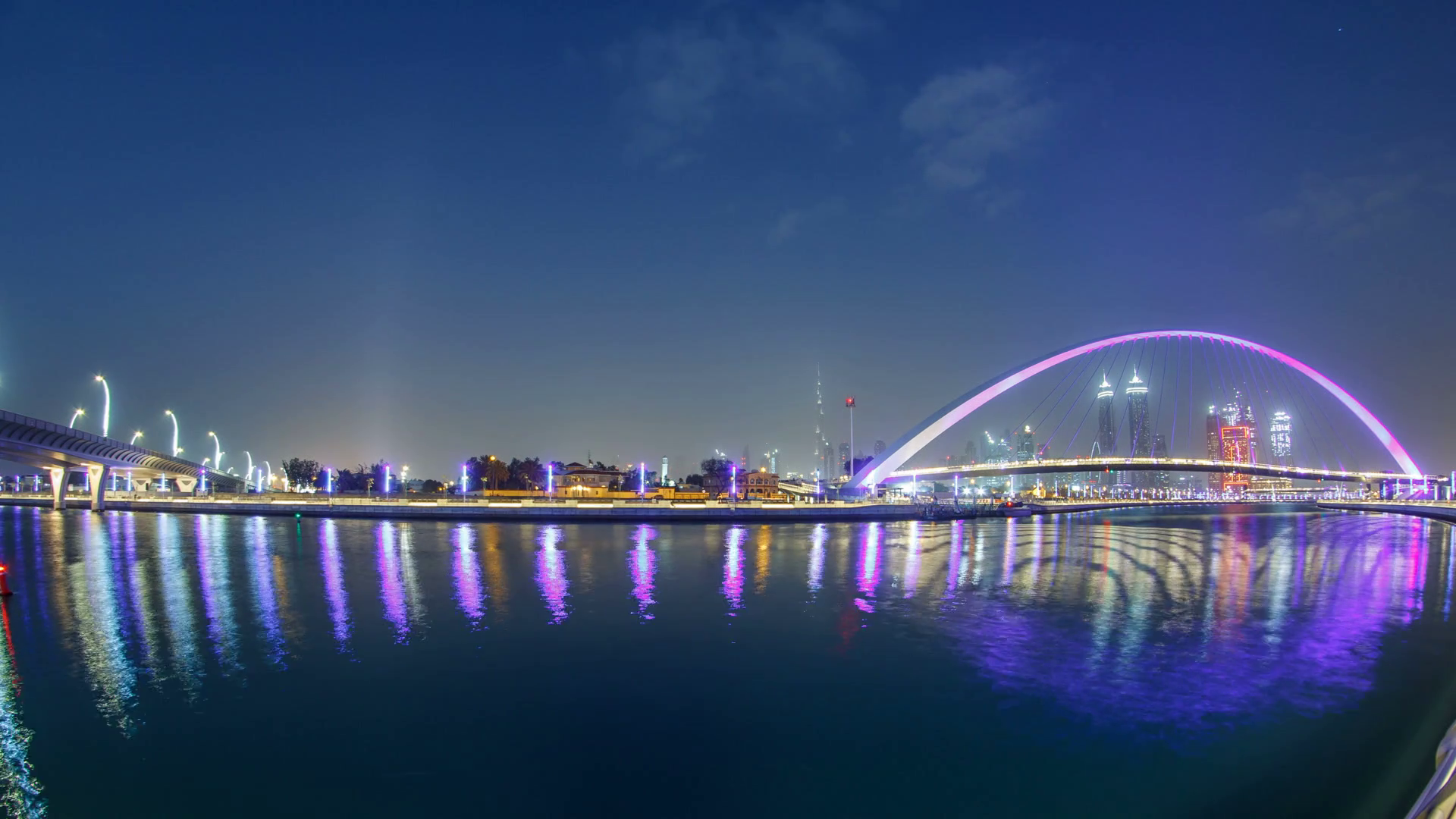 videoblocks-illuminated-pedestrian-bridge-over-the-dubai-water-canal-day-to-night-transition-timelapse-which-links-dubai-creek-to-jumeirah-beach-weaving-through-deira-downtown-dubai-and-safa-park-skys.png