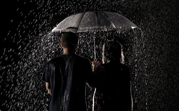 couple-standing-in-rain-with-umbrella.jpg