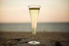 glass-champagne-background-sea-sunset-stone-wall-58701998.jpg