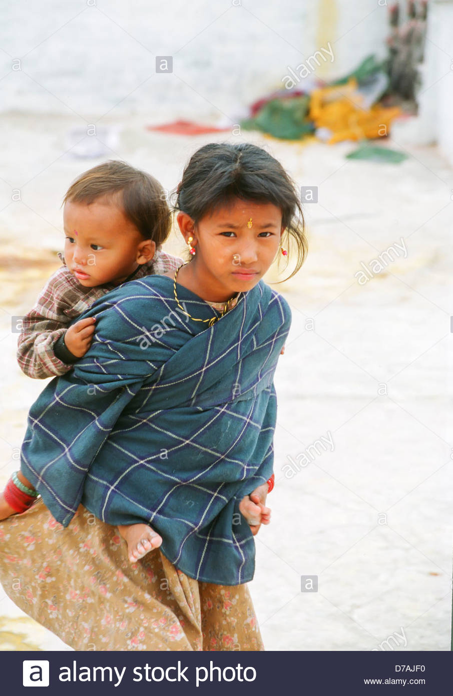 young-girl-beggar-carrying-a-small-child-on-her-back-begging-kathmandu-D7AJF0.jpg