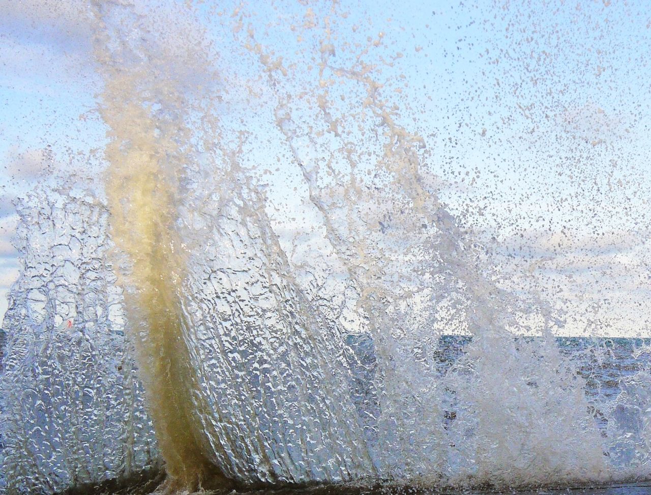 22712343428 - waves crash over the sea wall at high tide in.jpg