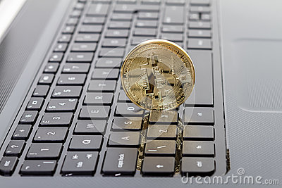 photo-golden-bitcoin-new-virtual-money-studio-shot-currency-laptop-close-up-front-side-45343987.jpg