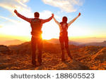 stock-photo-freedom-happy-couple-cheering-and-celebrating-hiking-man-and-woman-raising-arms-excited-in-188605523.jpg