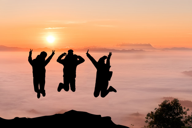 silhouettes-of-friends-jumping-on-mountain-peak-sport-and-active-life-concept_2379-793.jpg
