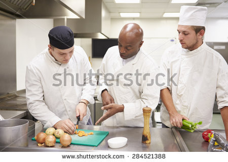 stock-photo-teacher-helping-students-training-to-work-in-catering-284521388.jpg