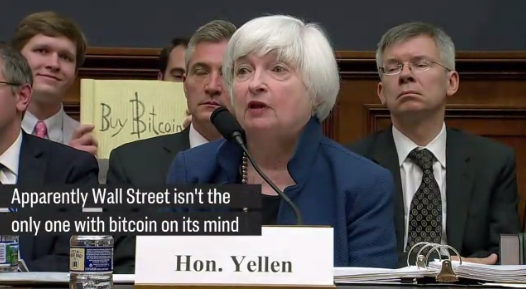 Random guy puts up Buy Bitcoin behind Janet Yellen.PNG