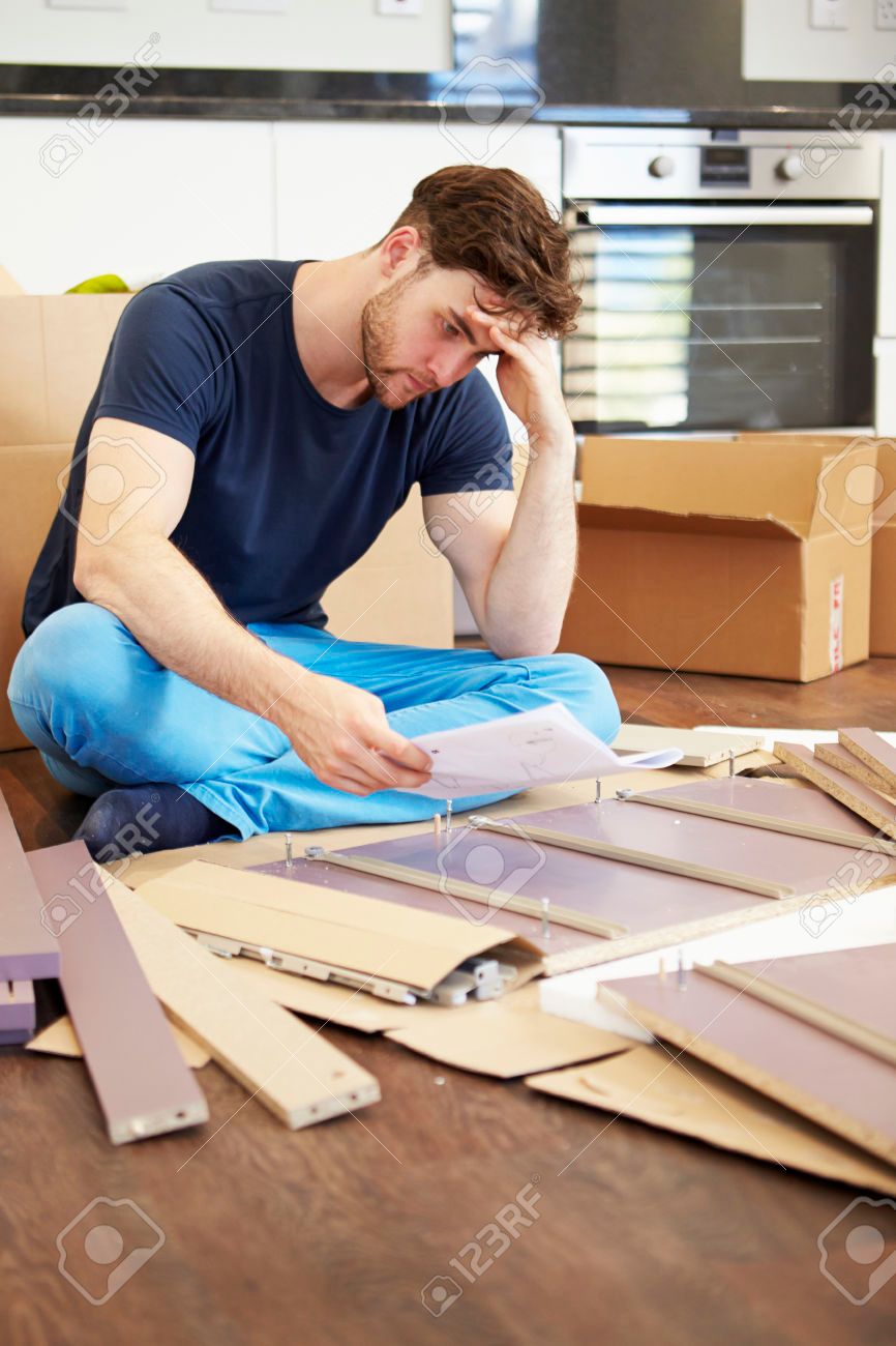 31010151-Frustrated-Man-Putting-Together-Self-Assembly-Furniture-Stock-Photo.jpg