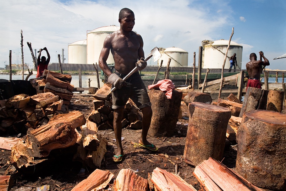 Image result for african man cutting wood